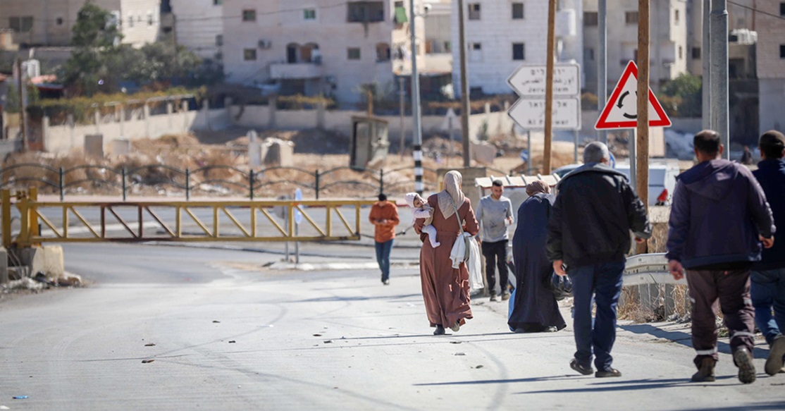 Palestinians in the West Bank cross a road closed by the Israeli army. Photo: Flash 90